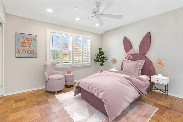 a spacious bedroom with a large bed and a chandelier