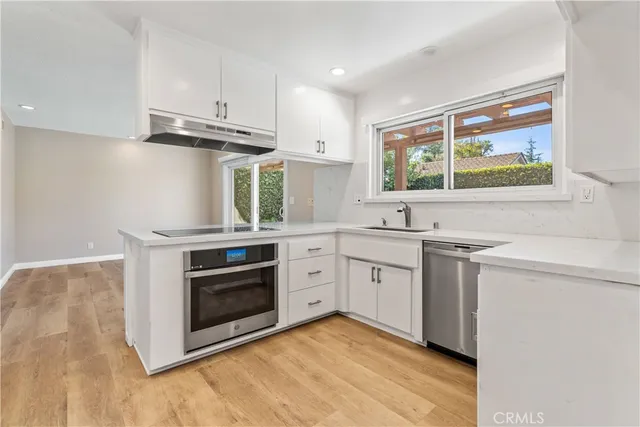 a kitchen with a stove oven and sink