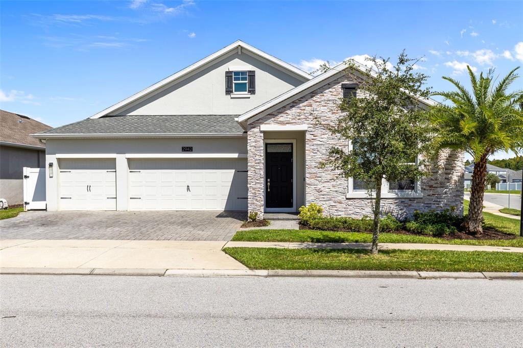 2942 Wordsmith Road Kissimmee, FL 34746 - Photo 1 of 1 a front view of a house with a yard and garage