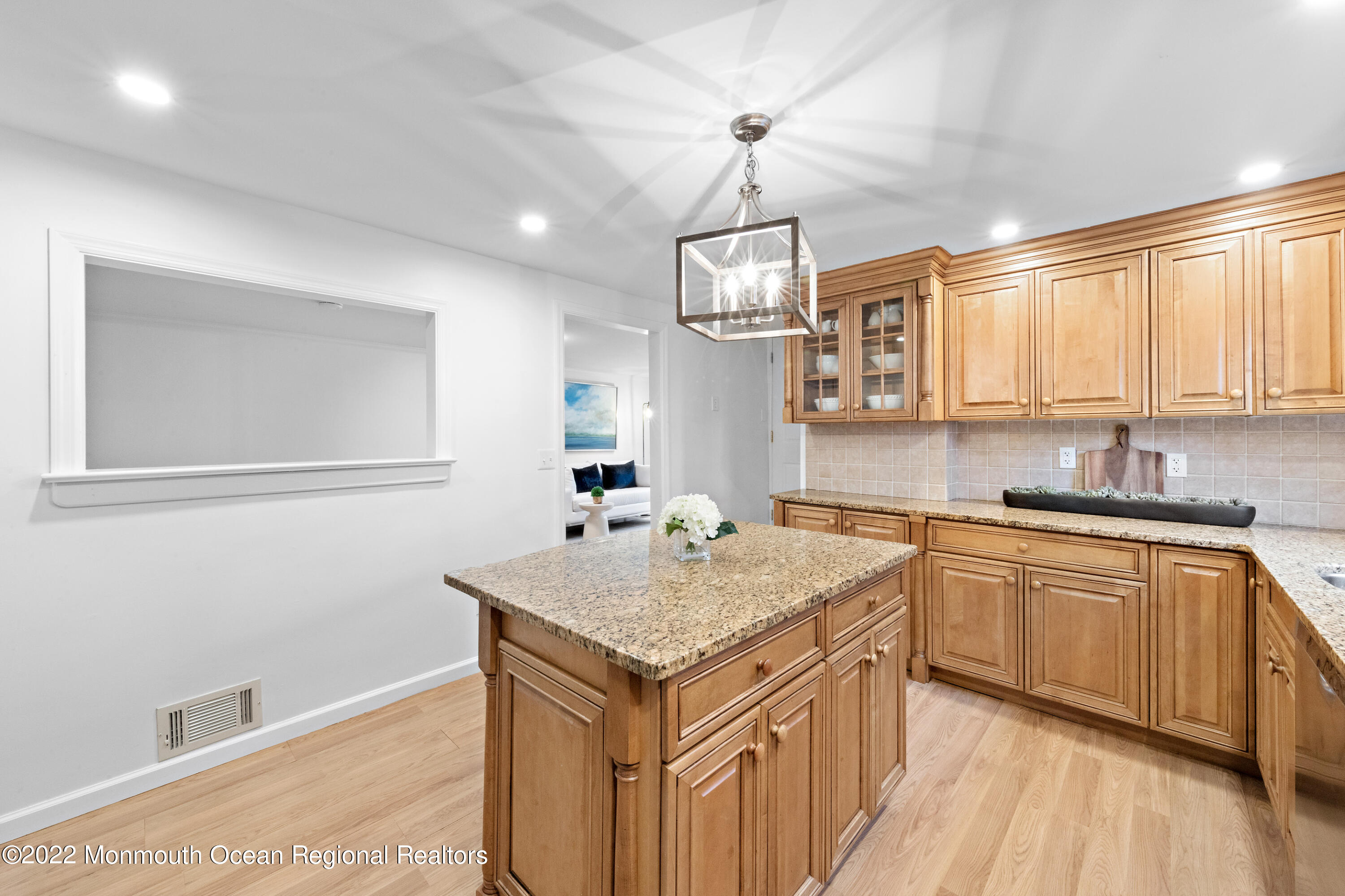 29 Church Street Rumson, NJ 07760 - Photo 15 of 42 a kitchen that has a sink a microwave oven a stove and white cabinets with wooden floor