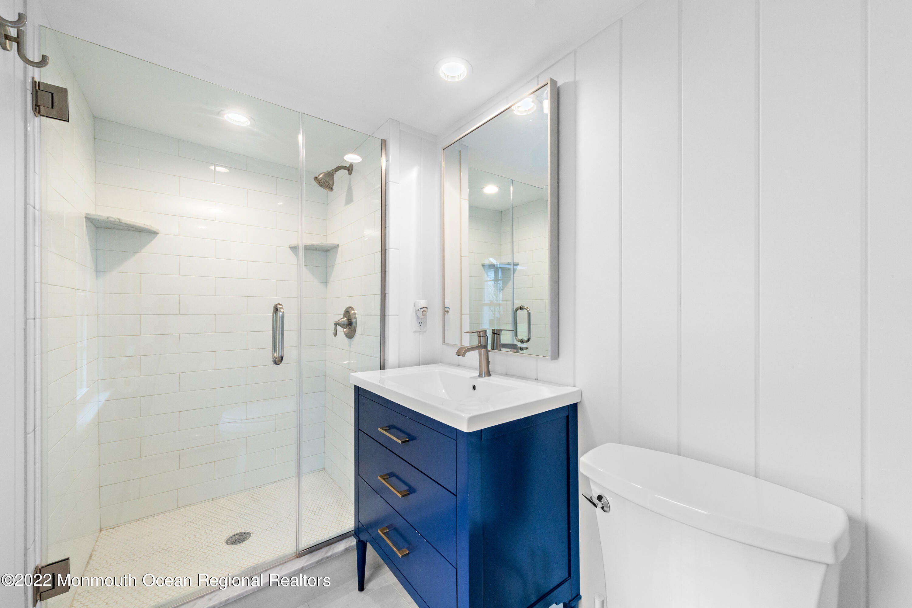 29 Church Street Rumson, NJ 07760 - Photo 20 of 42 a bathroom with a sink toilet a mirror and shower
