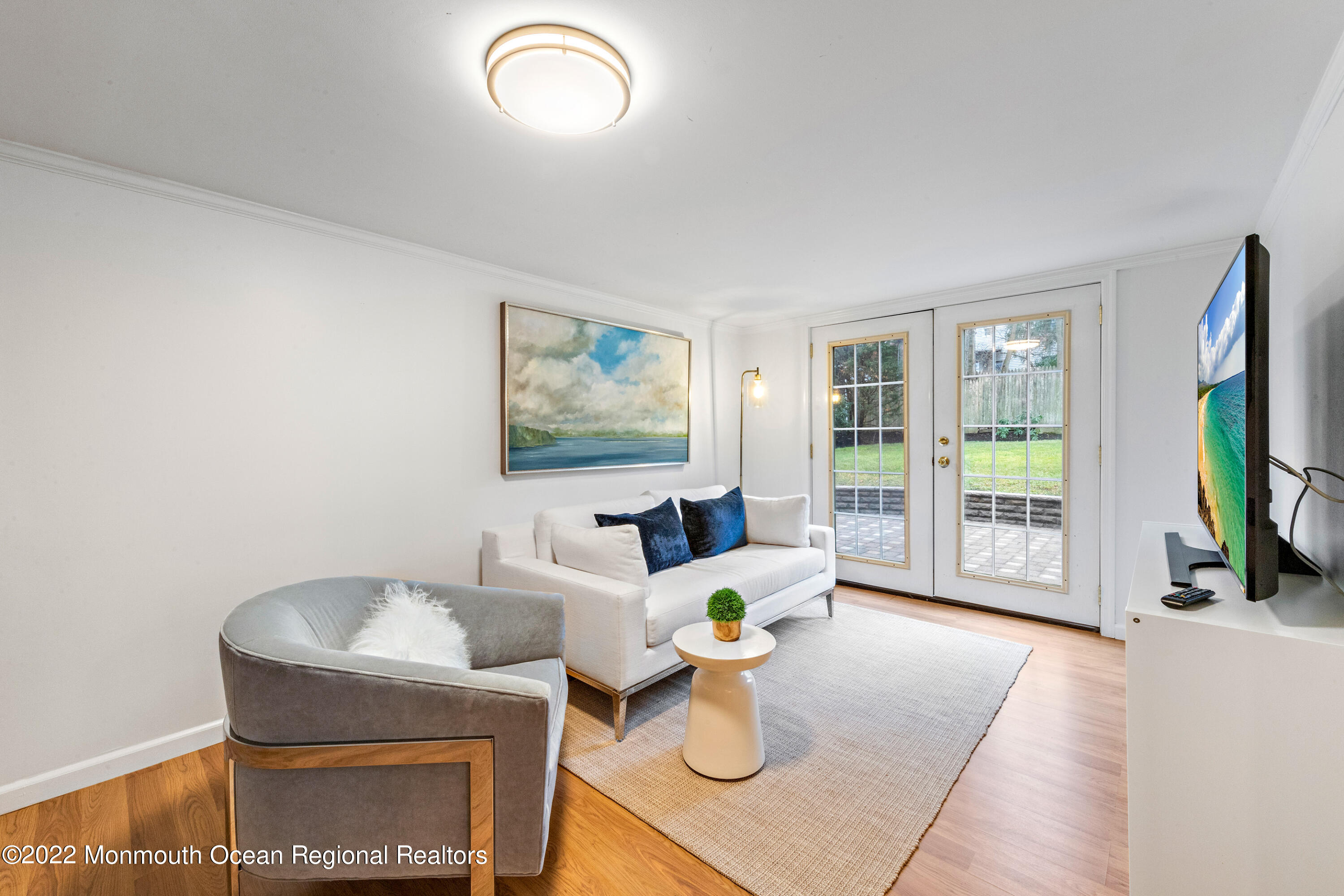 29 Church Street Rumson, NJ 07760 - Photo 22 of 42 a living room with furniture a flat screen tv and floor to ceiling window