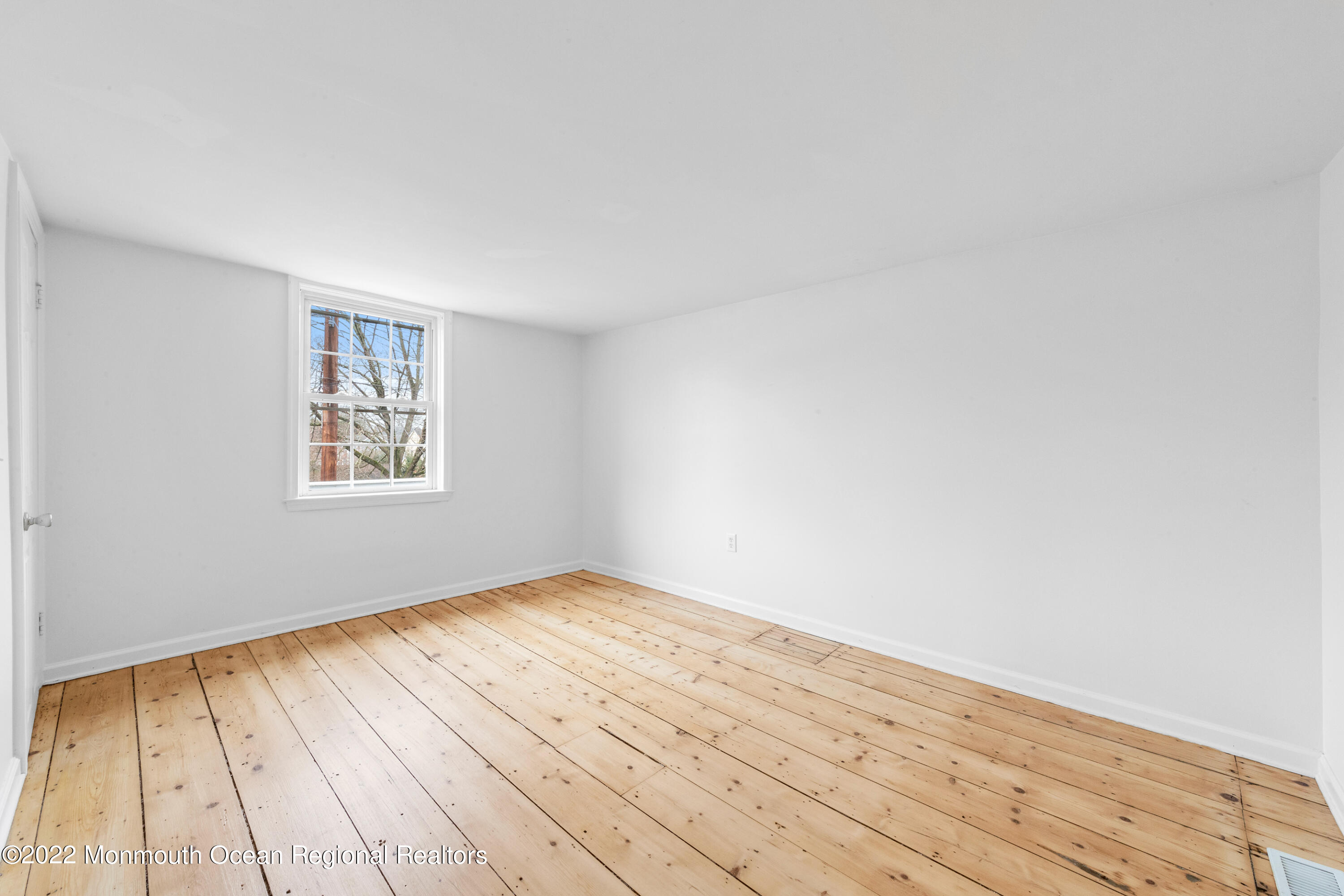 29 Church Street Rumson, NJ 07760 - Photo 28 of 42 a view of an empty room with wooden floor and a window