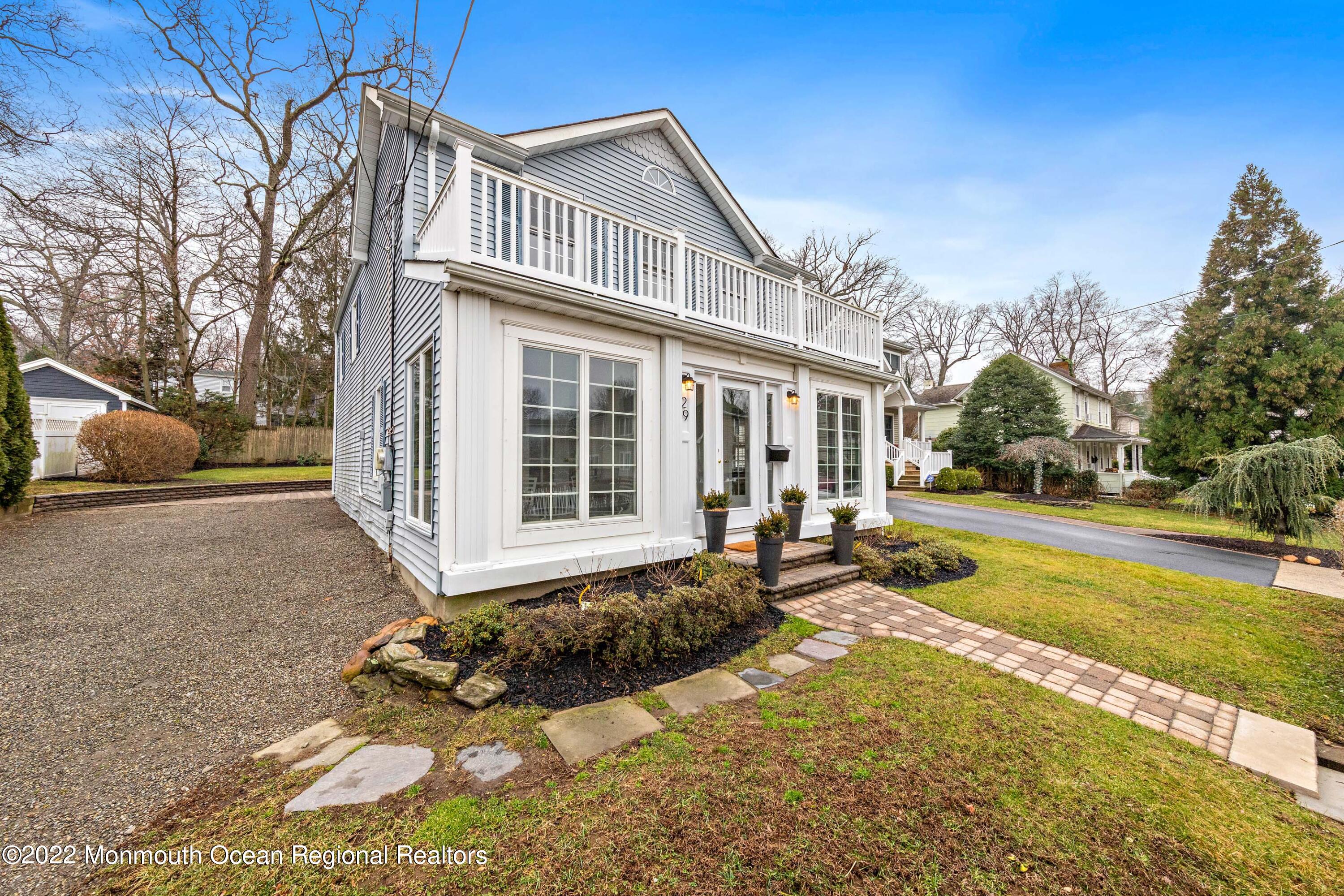 29 Church Street Rumson, NJ 07760 - Photo 4 of 42 a front view of a house with a yard outdoor seating and covered with trees