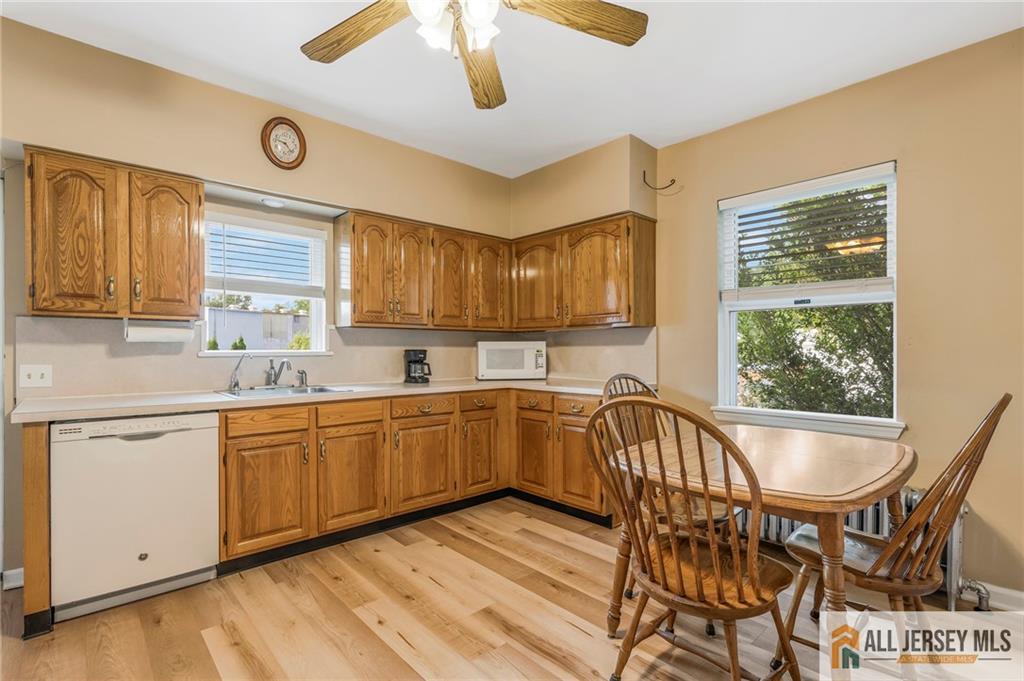 114 Runyon Avenue Middlesex, NJ 08846 - Photo 11 of 34 a kitchen with a table chairs sink and cabinets