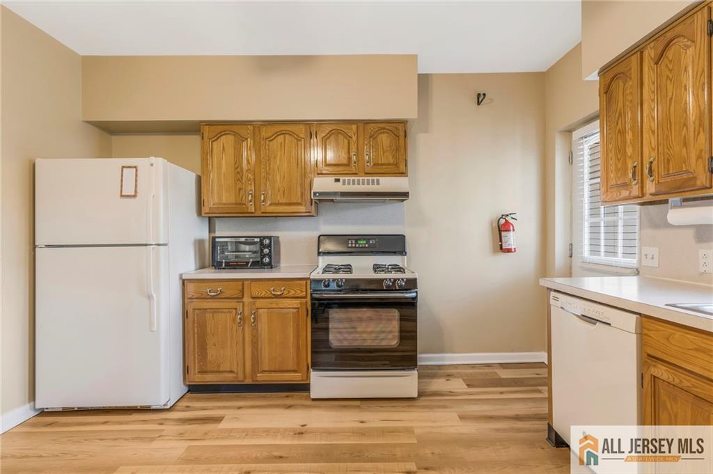 114 Runyon Avenue Middlesex, NJ 08846 - Photo 12 of 34 a kitchen with stainless steel appliances granite countertop a refrigerator a stove a sink and a microwave