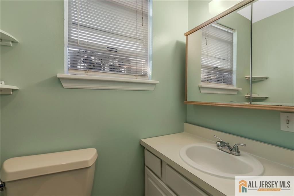 114 Runyon Avenue Middlesex, NJ 08846 - Photo 20 of 34 a bathroom with a sink a toilet and a mirror
