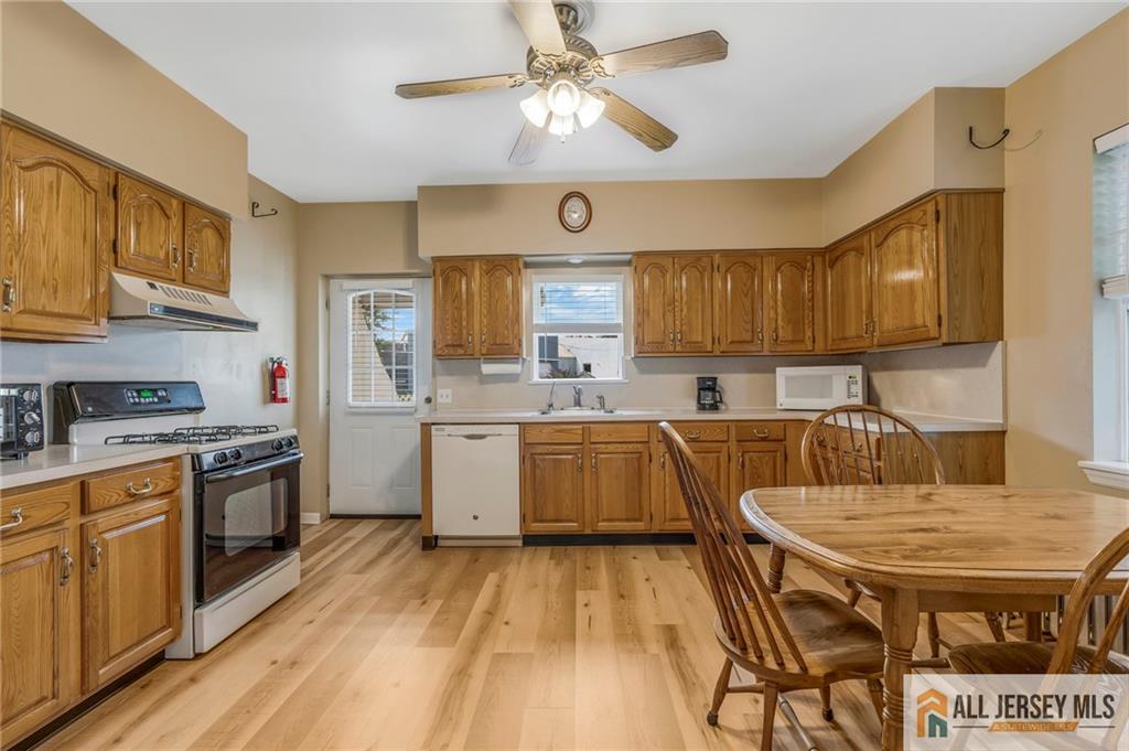 114 Runyon Avenue Middlesex, NJ 08846 - Photo 10 of 34 a kitchen with a table chairs stove and cabinets