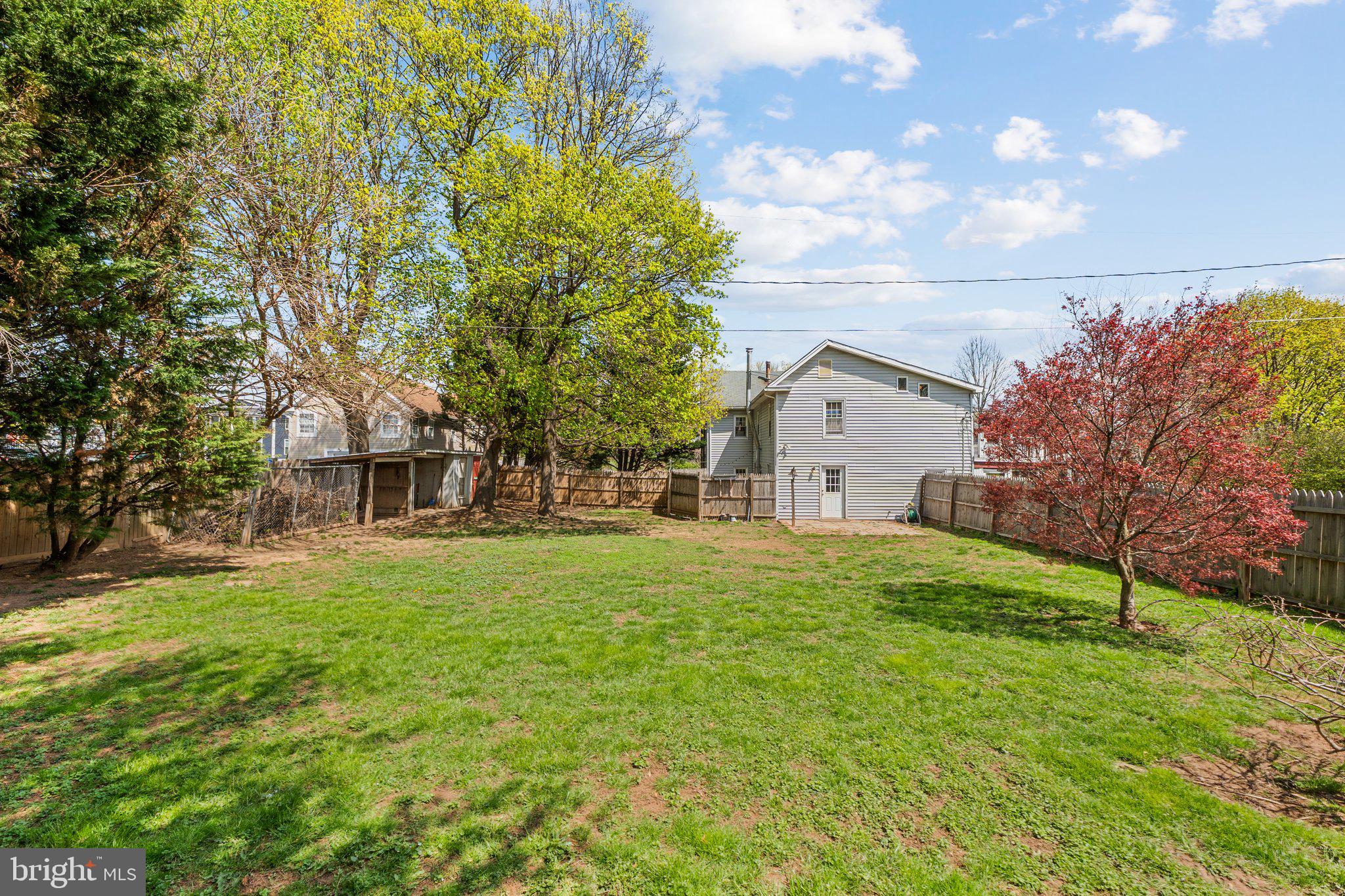 15921 Frederick Road Woodbine, MD 21797 - Photo 41 of 41 Spacious backyard with vibrant greenery.