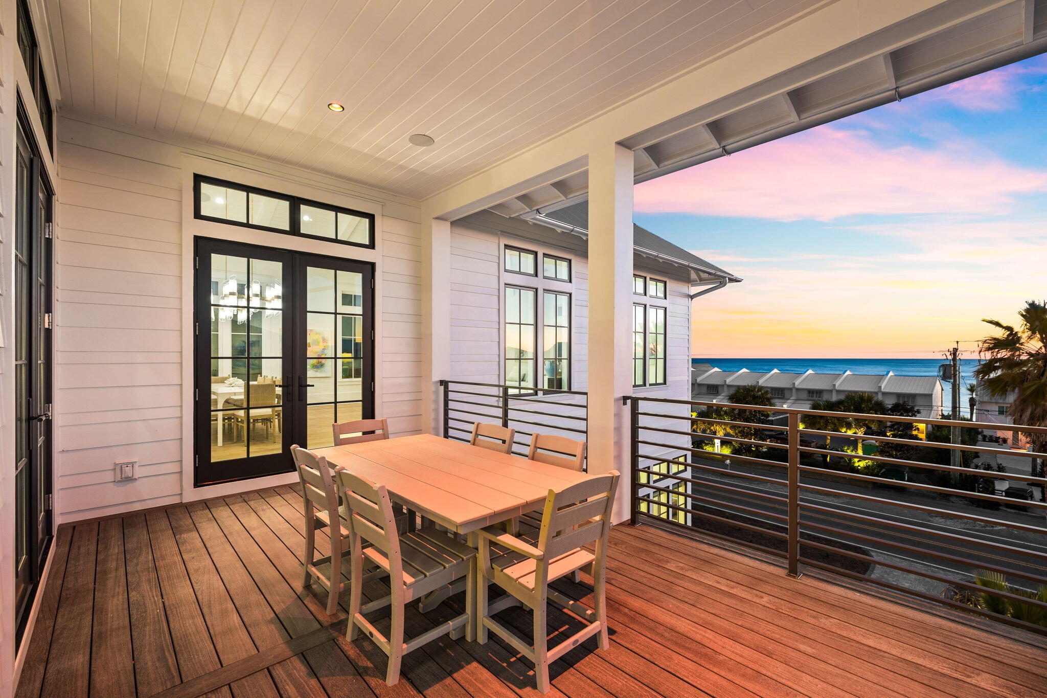 8103 East County Highway 30A Inlet Beach, FL 32461 - Photo 5 of 86 a view of a balcony with a dining table and chairs with wooden floor