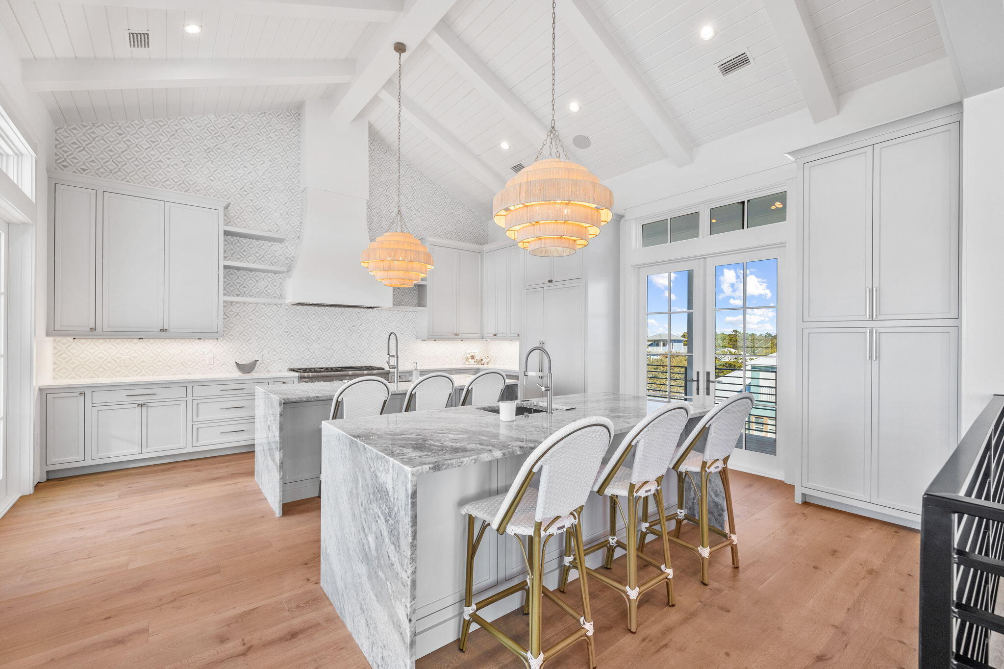 8103 East County Highway 30A Inlet Beach, FL 32461 - Photo 55 of 86 a large kitchen with kitchen island a large island a sink stainless steel appliances and cabinets