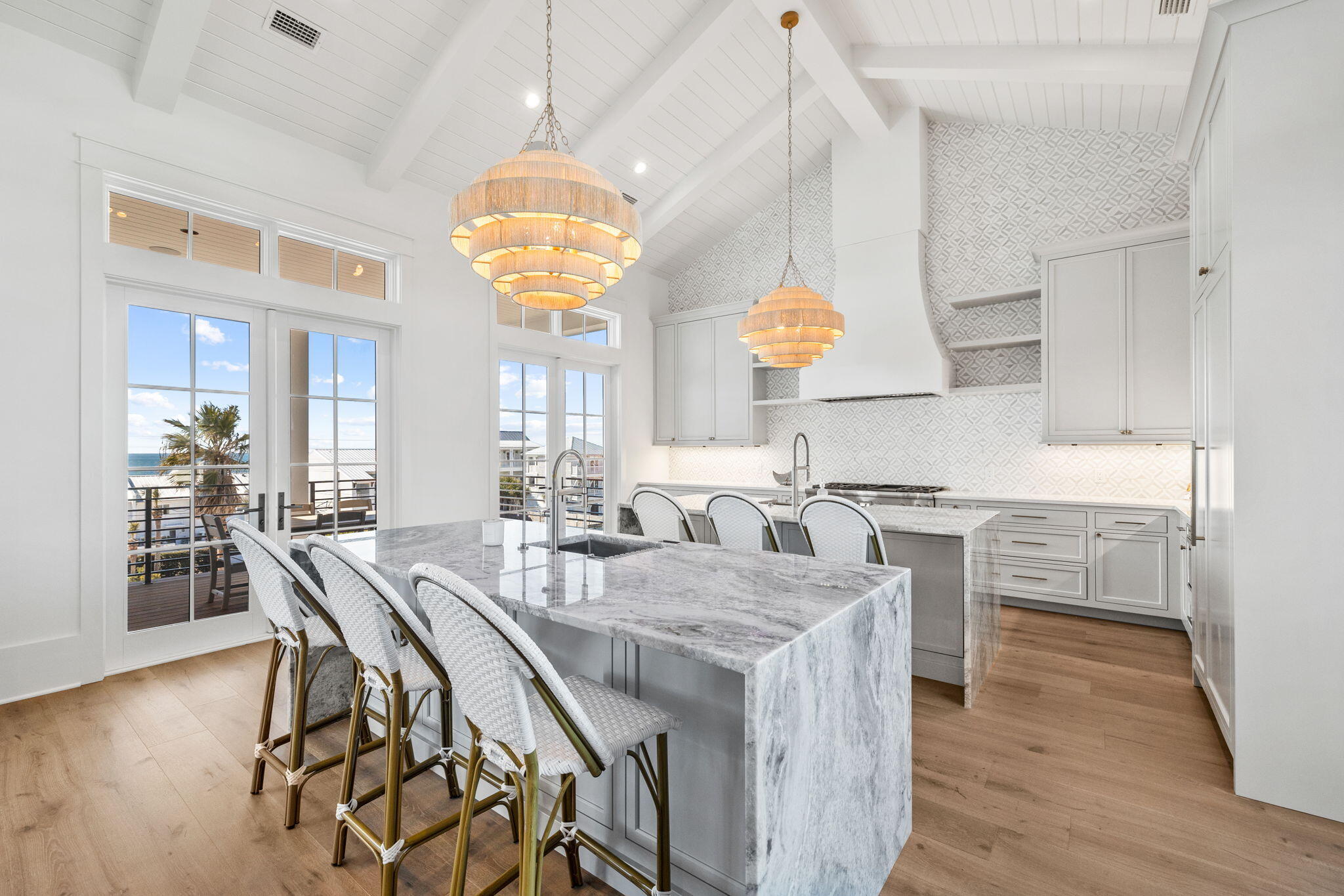 8103 East County Highway 30A Inlet Beach, FL 32461 - Photo 56 of 86 a kitchen with stainless steel appliances granite countertop a stove a kitchen island a table and chairs in it