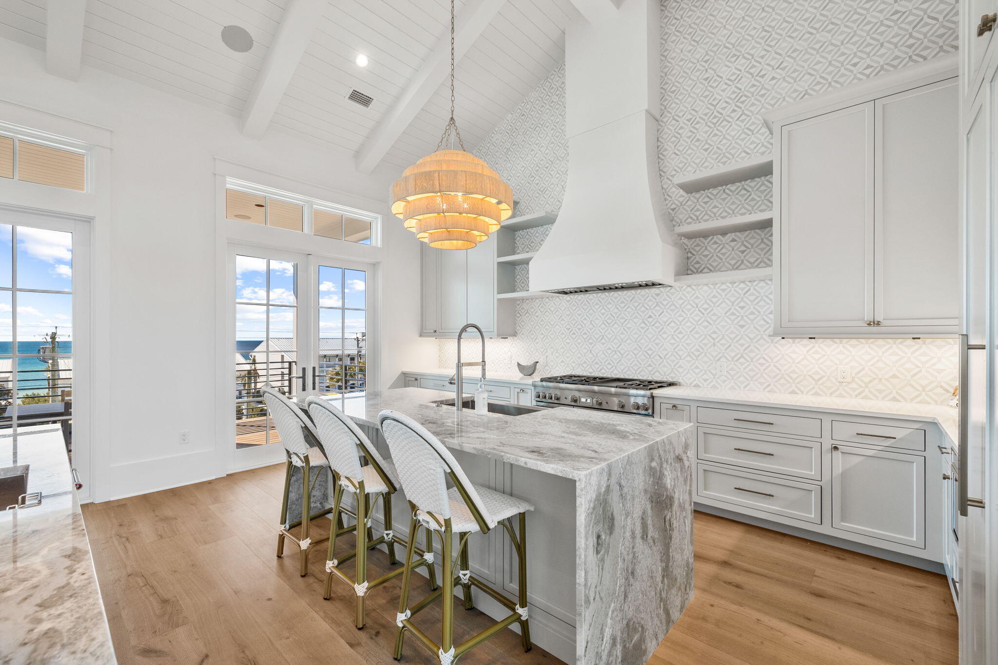 8103 East County Highway 30A Inlet Beach, FL 32461 - Photo 57 of 86 a kitchen with stainless steel appliances granite countertop a sink a stove and a wooden floors
