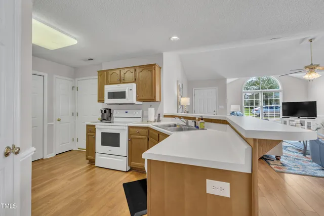 a kitchen with a sink stove and cabinets