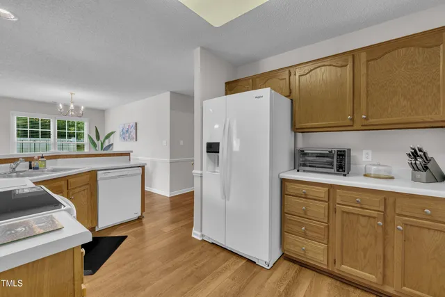 a kitchen with stainless steel appliances a refrigerator sink and cabinets