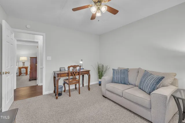 a living room with furniture and a chandelier