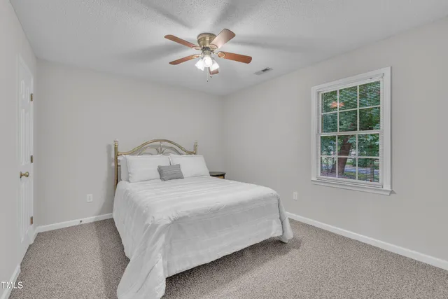 a bedroom with a bed and window