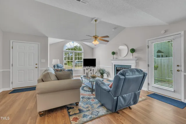 a living room with furniture and a fireplace