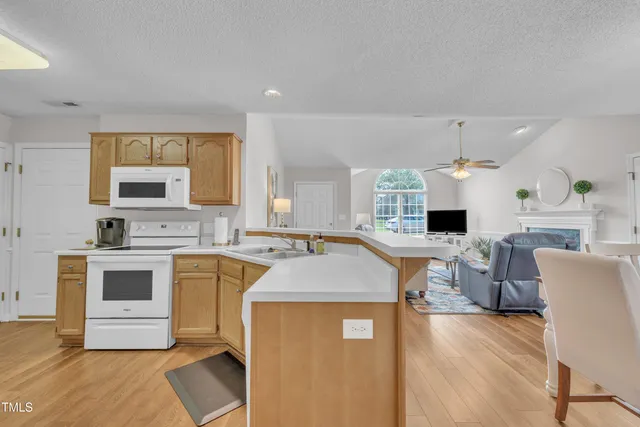 a large kitchen with a table and chairs in it