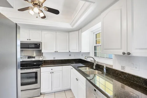a kitchen with stainless steel appliances granite countertop a sink and cabinets