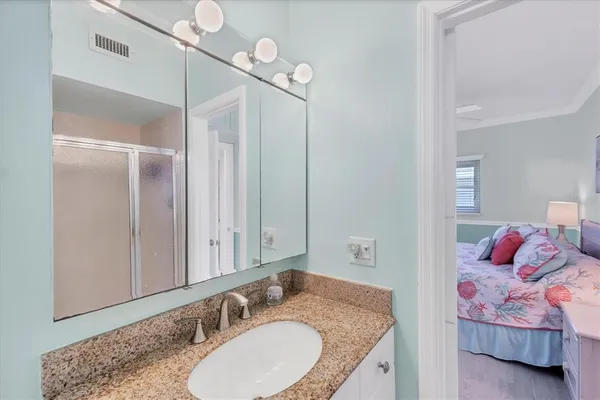 a bathroom with a granite countertop sink and a mirror