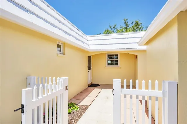 a front view of a house with wooden fence