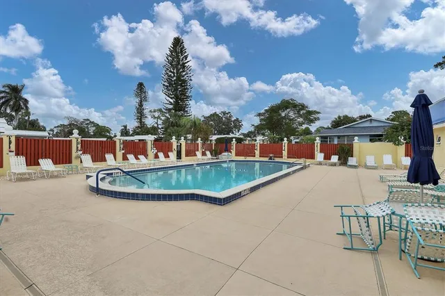 a view of a house with swimming pool and sitting area