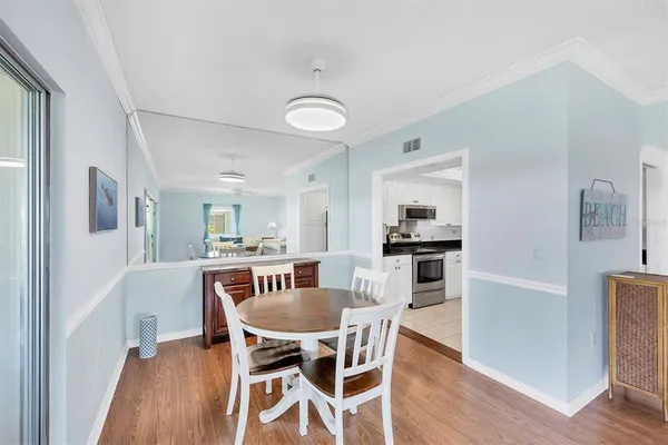 a view of a dining room with furniture window and wooden floor