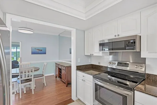 a kitchen with a stove and white cabinets