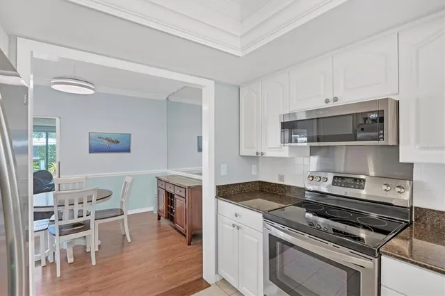 a kitchen with a stove and white cabinets