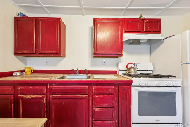 a kitchen with stainless steel appliances granite countertop a stove and cabinets
