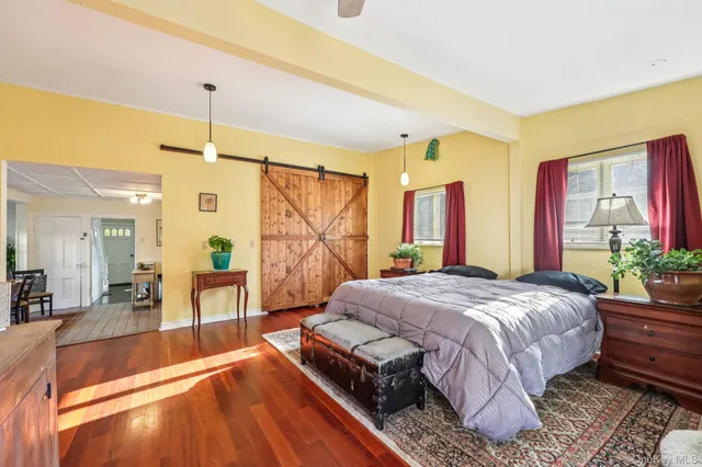 a spacious bedroom with a large bed and a chandelier