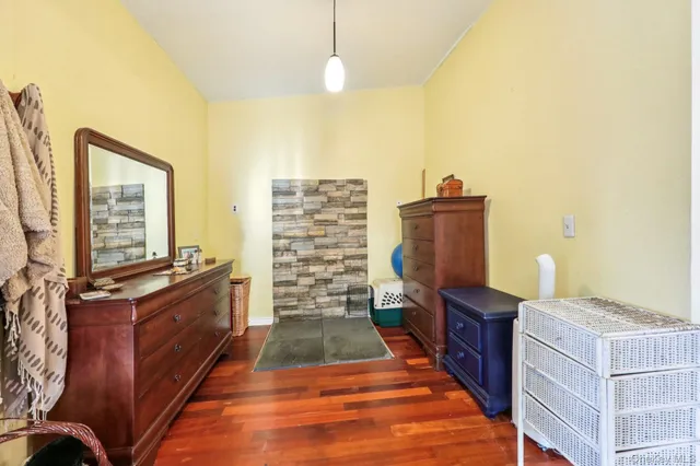 a room with furniture a air conditioner vent and a window