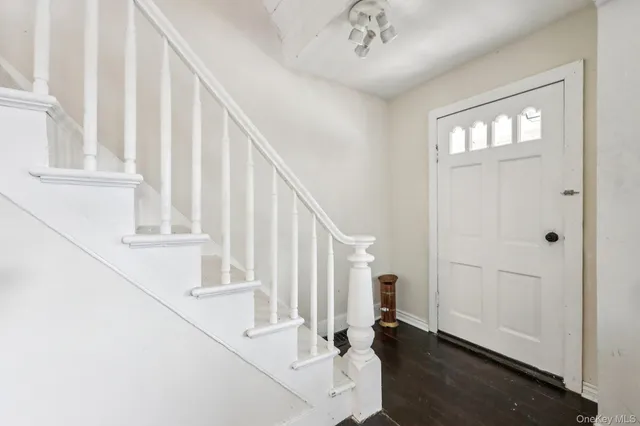 a view of staircase with white walls and a window