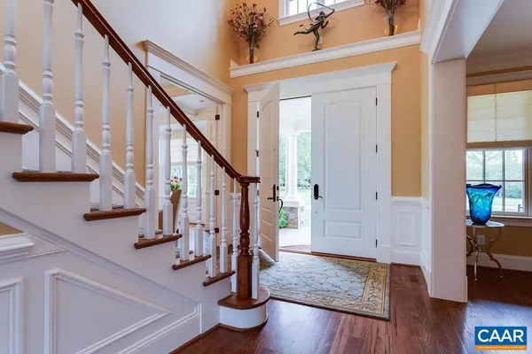 a living room with furniture a fireplace and a potted plant