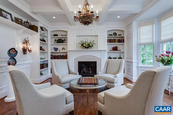 a kitchen with stainless steel appliances a stove a sink dishwasher a dining table and chairs with wooden floor