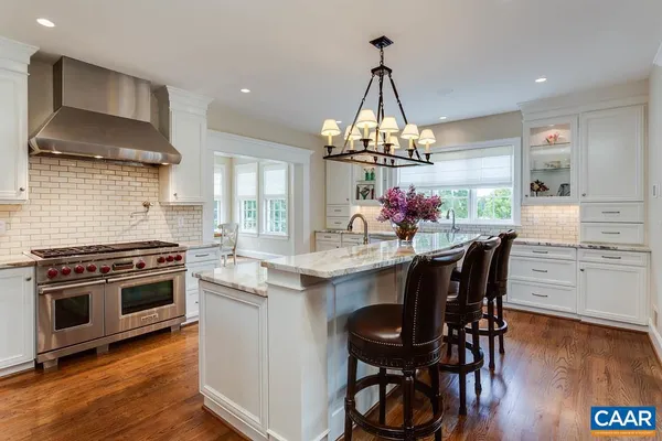 a kitchen with granite countertop a stove sink and cabinets