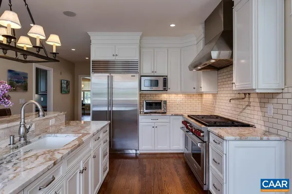 a view of kitchen with windows and chandelier