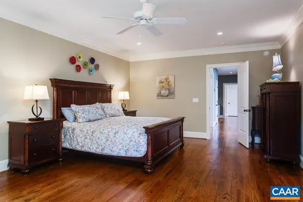 an empty room with chandelier fan and windows