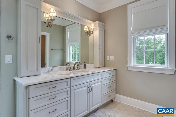 a bedroom with a bed lamp and a window