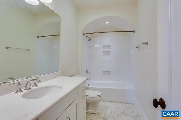 a view of an empty room with a fireplace and a window