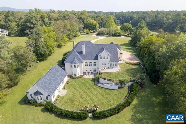 a view of a lake with mountains in the back yard
