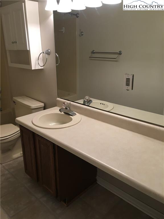 5416 Bamboo Road Boone, NC 28607 - Photo 19 of 24 a bathroom with a sink a toilet and mirror