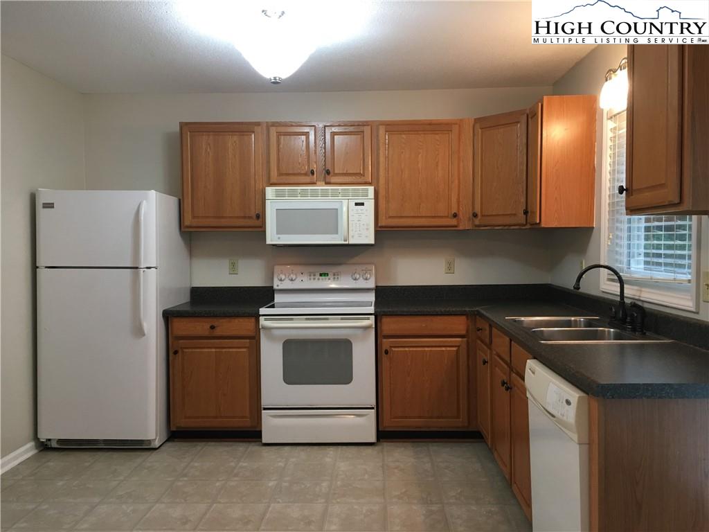 5416 Bamboo Road Boone, NC 28607 - Photo 2 of 24 a kitchen with stainless steel appliances granite countertop a sink stove and refrigerator