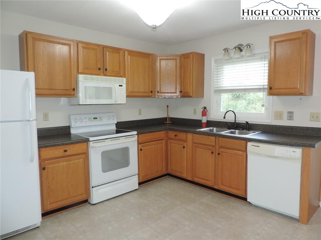 5416 Bamboo Road Boone, NC 28607 - Photo 3 of 24 a kitchen with stainless steel appliances granite countertop a sink stove and refrigerator