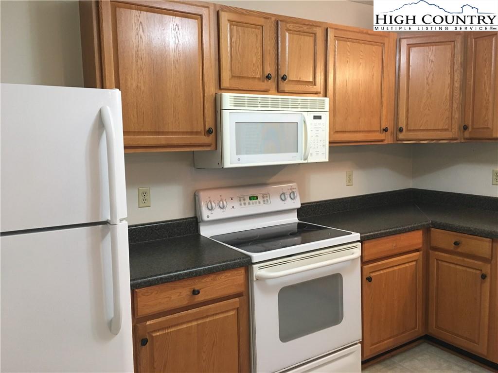 5416 Bamboo Road Boone, NC 28607 - Photo 6 of 24 a kitchen with cabinets and a refrigerator