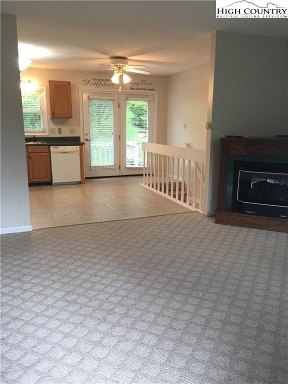5416 Bamboo Road Boone, NC 28607 - Photo 9 of 24 a view of an empty room with a fireplace and a window