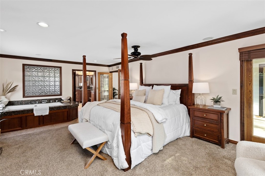 6421 East Bixby Hill Road Long Beach, CA 90815 - Photo 18 of 35 a spacious bedroom with a bed a couch and large window