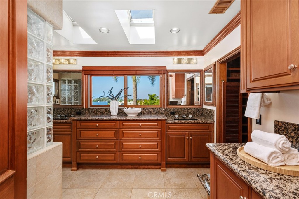 6421 East Bixby Hill Road Long Beach, CA 90815 - Photo 23 of 35 a kitchen with stainless steel appliances granite countertop a stove and more cabinets