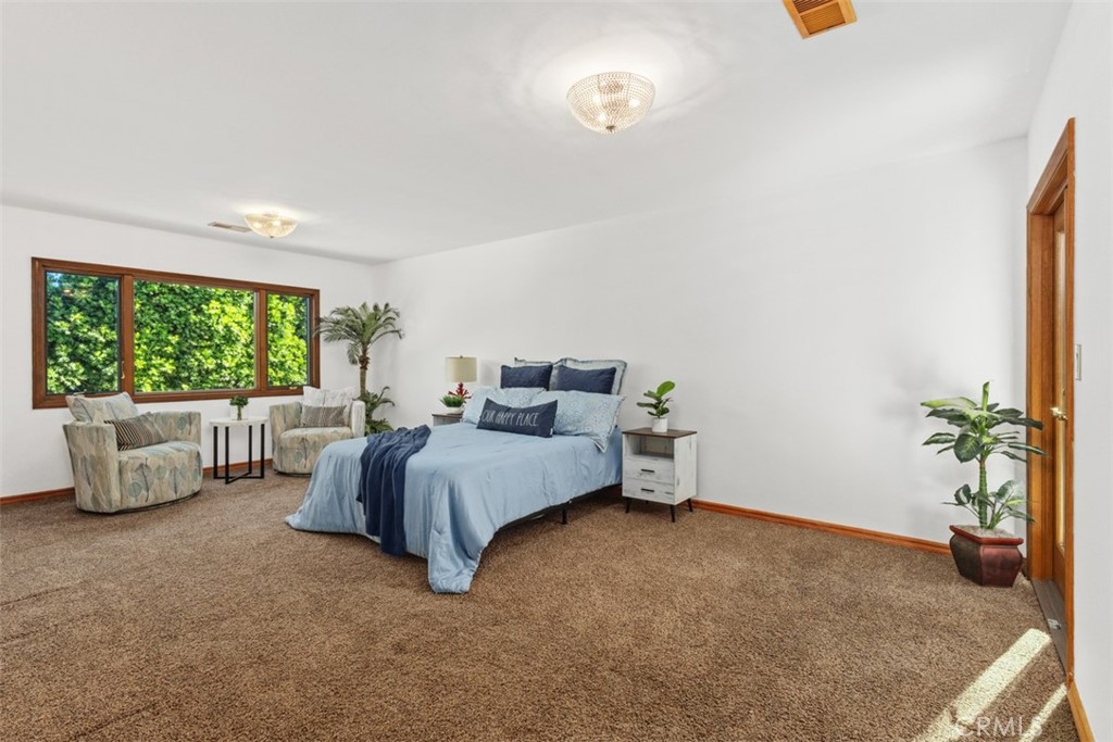 6421 East Bixby Hill Road Long Beach, CA 90815 - Photo 30 of 35 a bed room with a bed and a couch